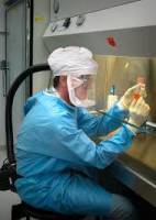 homme en tenue protectrcie travaillant en laboratoire